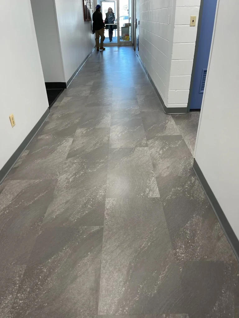 Gray stone-look tile flooring installed in a Connecticut commercial hallway